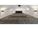 Finished theater room features tiered seating, wall sconces, neutral walls, and carpet at 1616 Hunting Ridge Rd, Raleigh, NC 27615