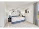 Cozy bedroom showcasing a blue daybed, neutral tones, and modern wall decor for a serene atmosphere at 169 Klamath Dr, Garner, NC 27529