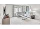 Cozy living room with plush gray seating, neutral carpet, a marble coffee table, and abundant natural light at 169 Klamath Dr, Garner, NC 27529