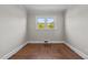 Bright bedroom featuring hardwood floors and a window offering natural light at 1802 Prince Edward Dr, Elon, NC 27244