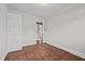 Bedroom with wood floors, showing closet to left, and entrance hallway at 1802 Prince Edward Dr, Elon, NC 27244