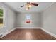 Bedroom with hardwood floor and nice view of the neighborhood street at 1802 Prince Edward Dr, Elon, NC 27244