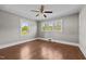 Spacious bedroom with hardwood floors, ceiling fan and natural light from multiple windows at 1802 Prince Edward Dr, Elon, NC 27244