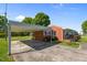 Home featuring a brick facade, carport and well-manicured landscaping at 1802 Prince Edward Dr, Elon, NC 27244