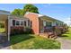 Charming single story home featuring a brick facade and well-manicured landscaping at 1802 Prince Edward Dr, Elon, NC 27244