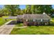 Charming exterior of the home boasting a covered parking area, lush landscaping and a well-kept lawn at 1802 Prince Edward Dr, Elon, NC 27244