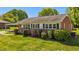 Exterior showcases a brick facade, covered parking, and a well-maintained lawn and landscaping at 1802 Prince Edward Dr, Elon, NC 27244