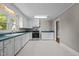Spacious kitchen features white cabinetry, ample countertop space, and stainless steel range at 1802 Prince Edward Dr, Elon, NC 27244