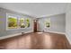 Bright living room featuring hardwood floors and large windows, perfect for comfortable living at 1802 Prince Edward Dr, Elon, NC 27244