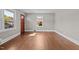 Well-lit living space with gleaming hardwood floors and fresh paint, offering a clean and modern look at 1802 Prince Edward Dr, Elon, NC 27244