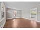 Cozy living area with hardwood floors and natural light, leading to the adjacent kitchen area at 1802 Prince Edward Dr, Elon, NC 27244