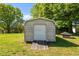 View of the exterior of a gray storage shed with a roll-up door at 1802 Prince Edward Dr, Elon, NC 27244