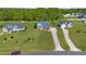 Suburban homes with large, green lawns, tree coverage and long driveways, creating a serene neighborhood setting at 192 Ash Lily Ct, Nashville, NC 27856