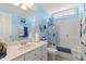 Bright bathroom with a large mirror, light blue walls, and a shower-tub combination with a shower curtain at 192 Ash Lily Ct, Nashville, NC 27856