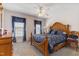 Bedroom showcasing a wooden bed frame, carpet, ceiling fan, and natural light at 192 Ash Lily Ct, Nashville, NC 27856