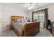 Bedroom featuring a wooden sleigh bed with decorative pillows, a ceiling fan, and carpeted floors at 192 Ash Lily Ct, Nashville, NC 27856