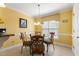 Cozy dining room featuring yellow walls, a glass table with chairs, and natural light at 192 Ash Lily Ct, Nashville, NC 27856