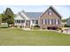 Charming two-story home showcasing a landscaped yard, brick accents, and inviting front porch at 192 Ash Lily Ct, Nashville, NC 27856