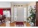 Bright foyer featuring hardwood floors, white trim, and a view into the adjacent dining room at 192 Ash Lily Ct, Nashville, NC 27856
