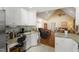 Open kitchen view with granite countertops, white cabinets, and an adjacent living area at 192 Ash Lily Ct, Nashville, NC 27856