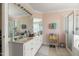 Bright main bathroom with double vanity, large mirror, and tile flooring at 192 Ash Lily Ct, Nashville, NC 27856