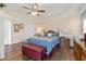 Bright main bedroom with ceiling fan, wood laminate floors, and a comfortable bed at 192 Ash Lily Ct, Nashville, NC 27856