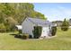 Shed in the backyard with manicured shrubbery and a small carport at 192 Ash Lily Ct, Nashville, NC 27856