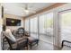 Sunroom featuring wicker furniture, large sliding windows offering a bright space, and tiled floors at 192 Ash Lily Ct, Nashville, NC 27856