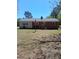 Backyard view of a brick home showing windows, trees, lawn, and rear brick siding at 19461 Nc Highway 210, Angier, NC 27501