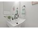 Stylish powder room with white pedestal sink and black fixtures at 2019 James St, Durham, NC 27707
