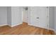 A bedroom with hardwood floors, white trim, and a double-door closet for ample storage at 2019 James St, Durham, NC 27707