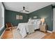 Comfortable bedroom with hardwood floors, ceiling fan, accent chair, and a light color scheme at 2019 James St, Durham, NC 27707