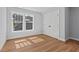 This bedroom features hardwood floors, a double-door closet, and bright windows at 2019 James St, Durham, NC 27707