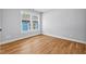 The bedroom has hardwood floors, white baseboards, and a bright window with exterior views at 2019 James St, Durham, NC 27707