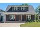 Charming two-story home features a covered front porch, beautiful windows, and well-maintained landscaping at 2019 James St, Durham, NC 27707