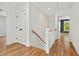 Hallway with hardwood floors, stairs, and access to multiple rooms at 2019 James St, Durham, NC 27707