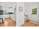 Bright, modern kitchen with white cabinets, hardwood floors, and stainless steel appliances at 2019 James St, Durham, NC 27707