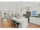 Bright, open kitchen features a large island with bar stools and stainless steel appliances at 2019 James St, Durham, NC 27707