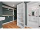 Bright, spacious walk-in closet, leading to a modern bathroom, with built-in shelving at 2019 James St, Durham, NC 27707