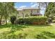 Backyard of home features a lush lawn, mature trees, and covered deck at 205 Lippershey Ct, Cary, NC 27513