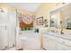Bright bathroom features a shower, soaking tub, and white cabinets with marble countertops at 205 Lippershey Ct, Cary, NC 27513