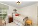 Comfortable bedroom with floral bedding, carpet flooring, window, and side tables at 205 Lippershey Ct, Cary, NC 27513