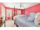 Pink bedroom with four-poster bed, bright light, and fresh white accents at 205 Lippershey Ct, Cary, NC 27513