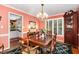 Charming dining room featuring a wooden dining set, a decorative chandelier and an arched entrance at 205 Lippershey Ct, Cary, NC 27513