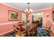 Elegant dining room featuring a large chandelier, traditional furniture and views of the backyard at 205 Lippershey Ct, Cary, NC 27513