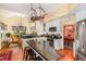 Well-equipped kitchen with white cabinets, granite countertops, an island with seating, and stainless steel appliances at 205 Lippershey Ct, Cary, NC 27513