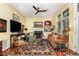Bright living room boasts natural light with a fireplace, ceiling fan and wet bar at 205 Lippershey Ct, Cary, NC 27513