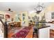 Open living space with hardwood floors, ample windows, a kitchen island, and an adjacent living room at 205 Lippershey Ct, Cary, NC 27513