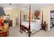 Serene main bedroom boasts a four-poster bed, walk-in closet and ensuite bathroom at 205 Lippershey Ct, Cary, NC 27513