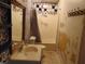 An untidy bathroom features a single sink and shower-tub combo at 223 S Main St, Wendell, NC 27591